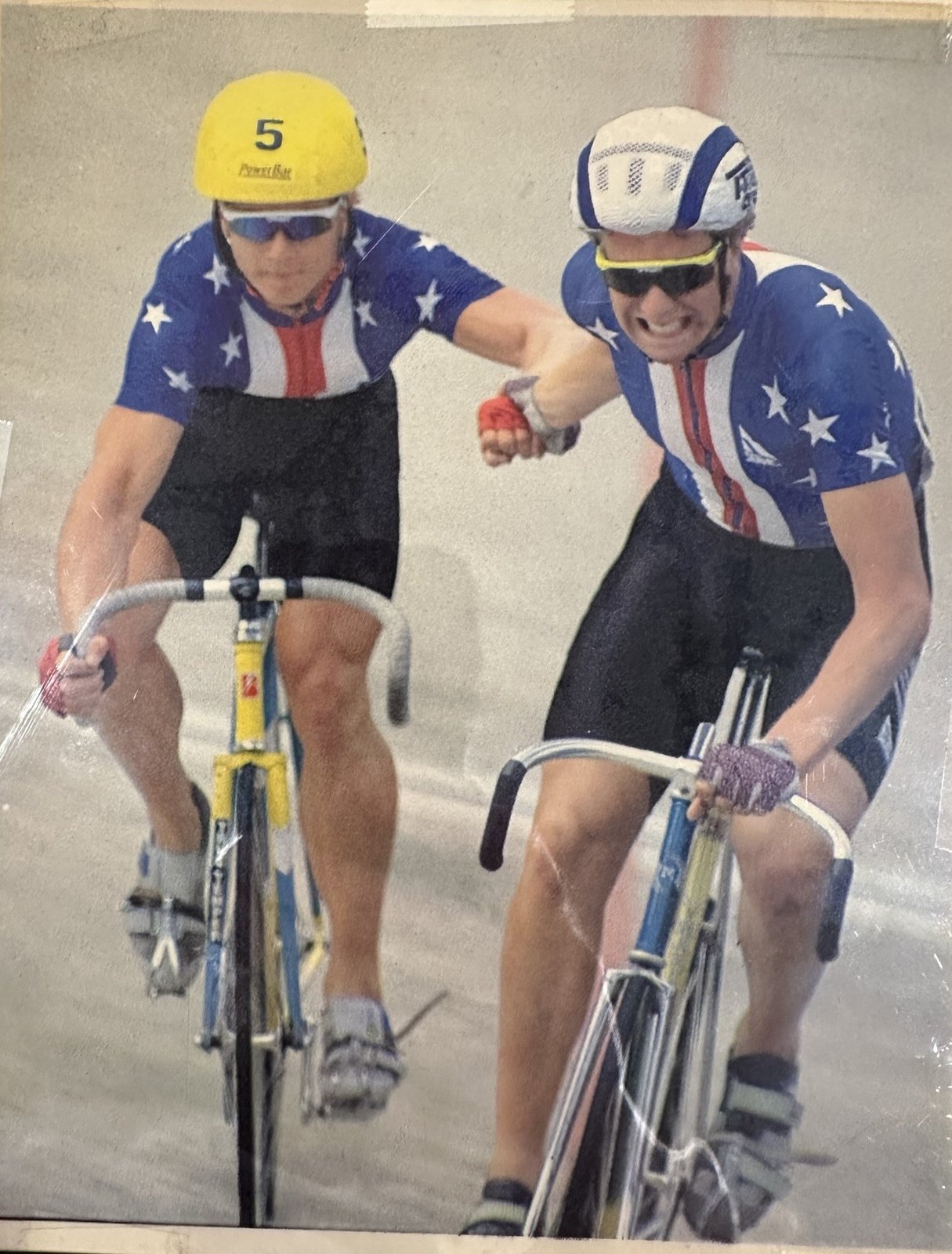 A madison hand-sling exchange on the track in US national team kit