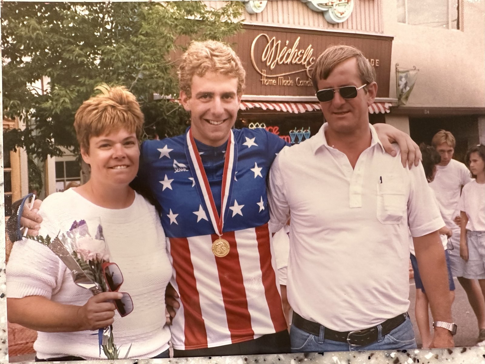 Tim Quigley in the stars and stripes champion's jersey with his parents
